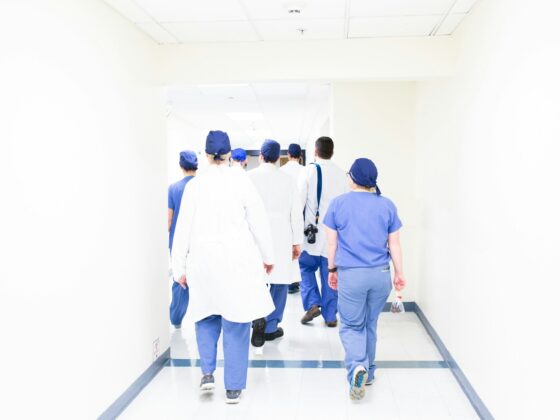 group of doctors walking on hospital hallway