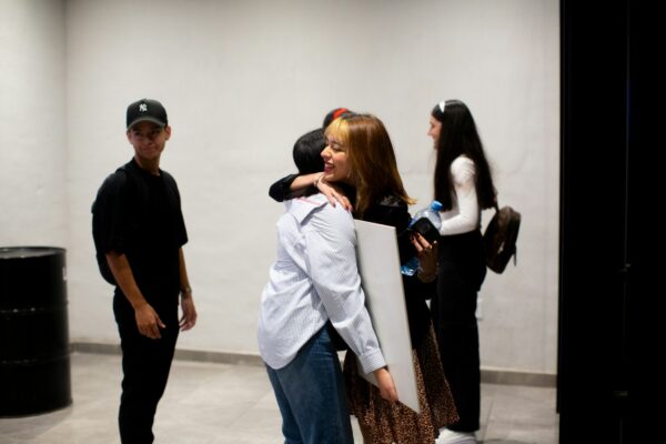 A group of people standing around each other