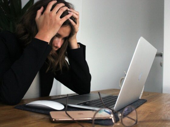 a woman sitting in front of a laptop computer