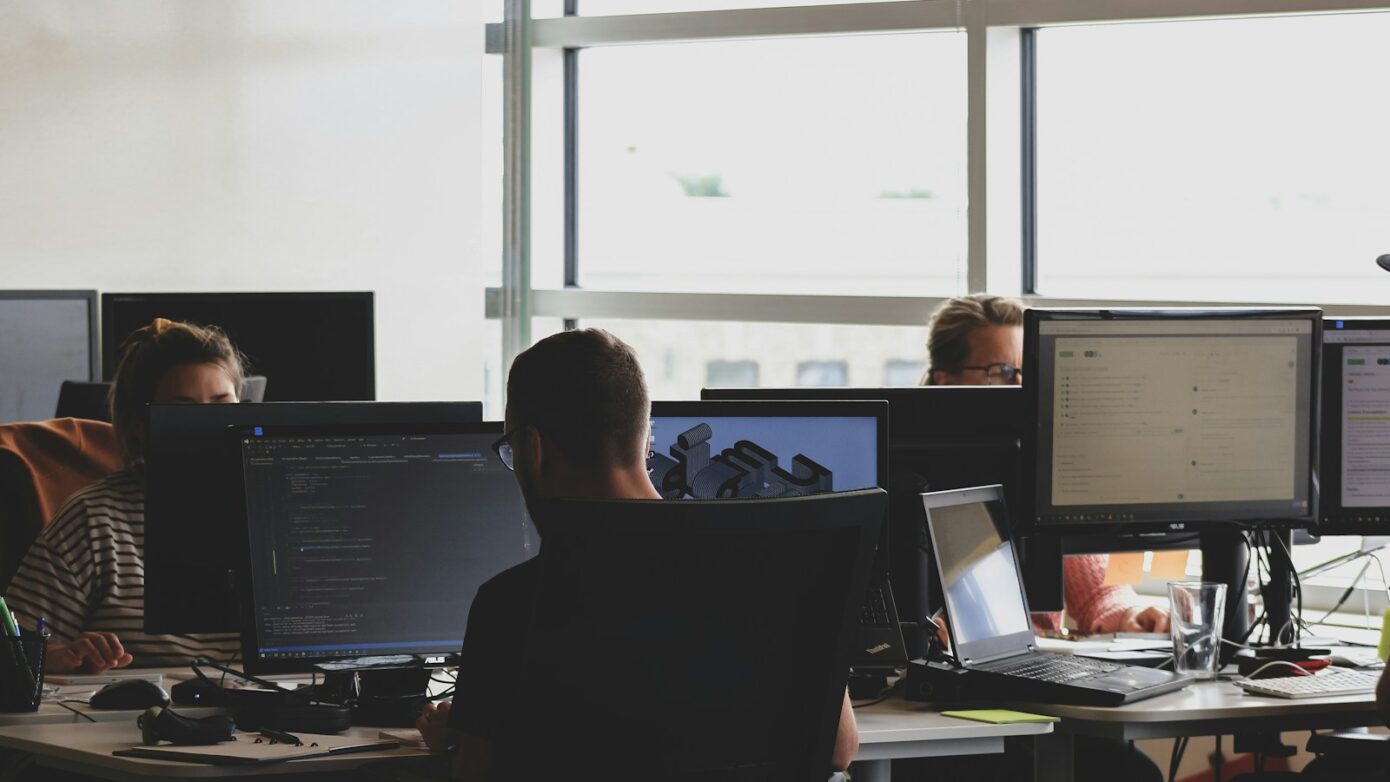 people sitting on chair in front of computer monitor