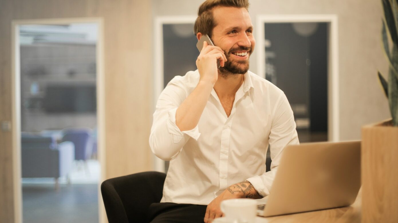 man using smartphone on chair